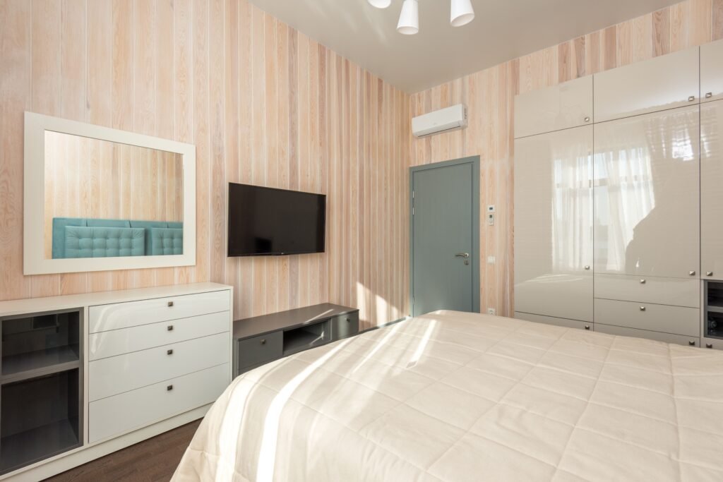 Modern master bedroom with hidden storage, featuring built-in cabinets, under-bed storage, sleek furniture, and a clean contemporary design.