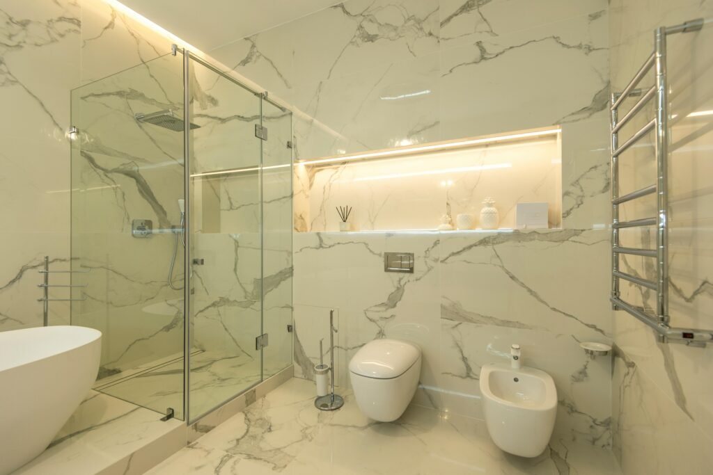 Spa-inspired modern bathroom with a freestanding tub, natural materials, soft lighting, and a calming atmosphere.