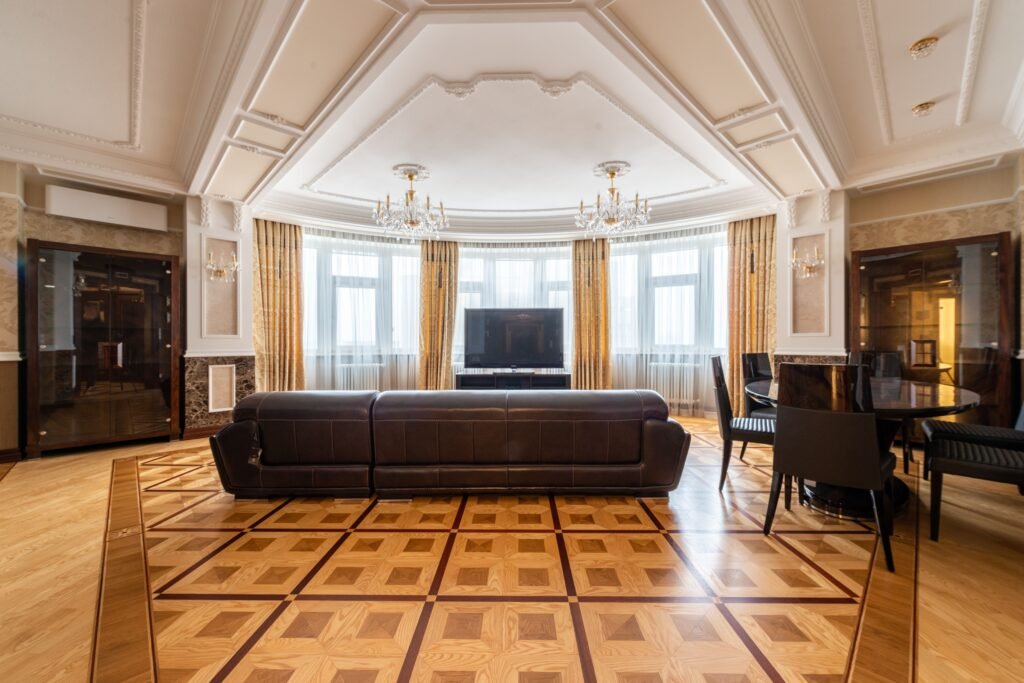 Grand coffered ceiling in a large room featuring deep recessed panels, elegant trim work, and a spacious layout that enhances the room's architectural appeal.