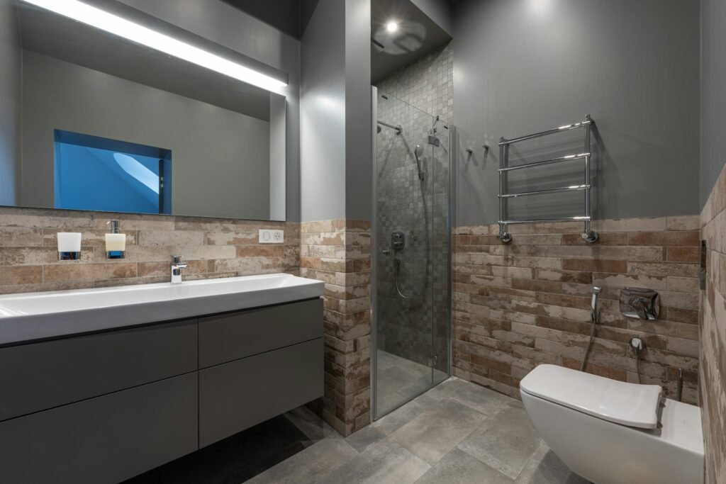 Modern bathroom designed for comfort with ergonomic fixtures, soft lighting, spacious layout, and elegant contemporary finishes.