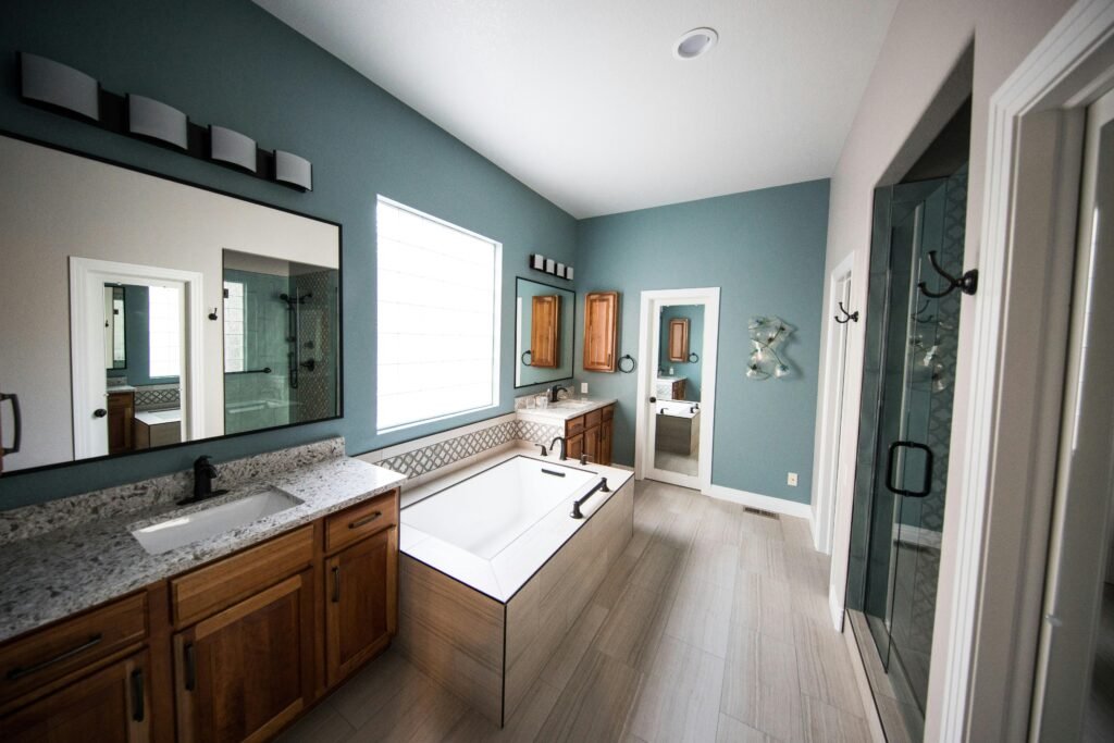 Modern bathroom ideas featuring a luxurious bathroom with warm neutral colours, a floating vanity, freestanding bathtub, walk-in shower, and soft ambient lighting.