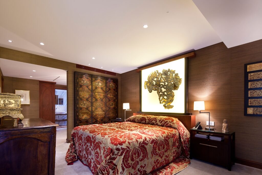 Modern master bedroom with large artwork focus, featuring a bold statement art piece above the bed, neutral décor, and contemporary interior design.