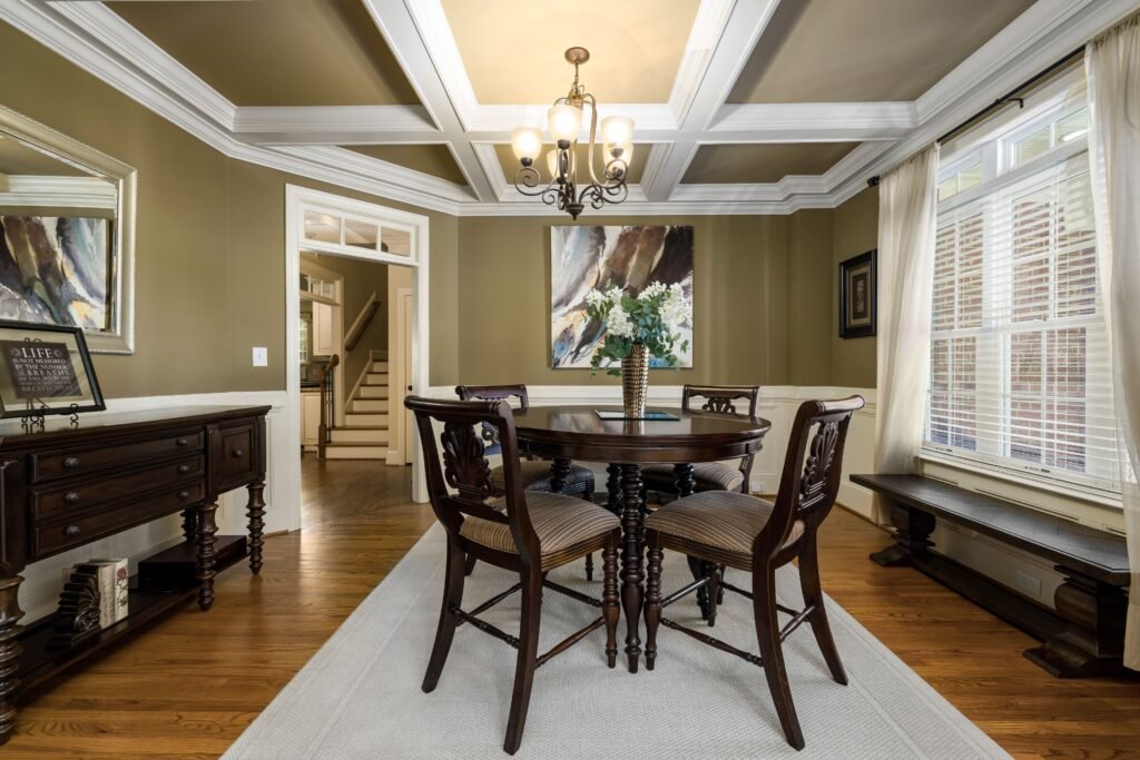 Traditional coffered ceiling with detailed molding, symmetrical recessed panels, and elegant craftsmanship that enhances the home's classic interior design.