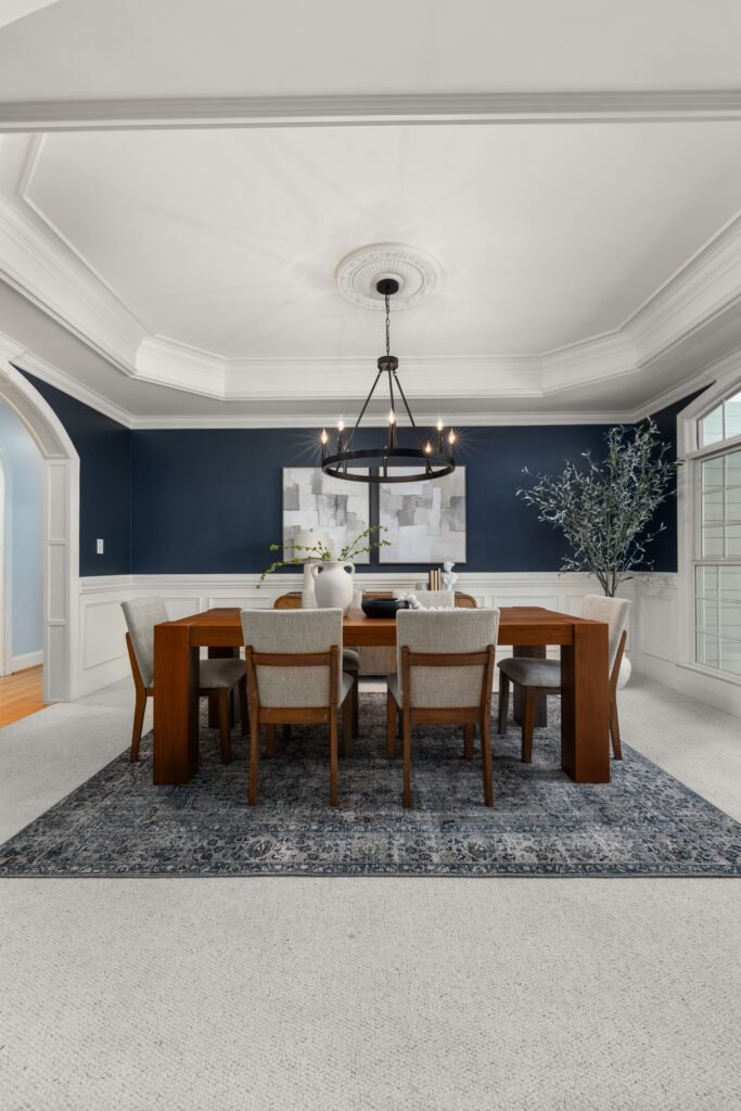 Modern dining room featuring a stylish area rug under a contemporary dining table, elegant chairs, neutral decor, and sophisticated accents inspired by modern dining room ideas.