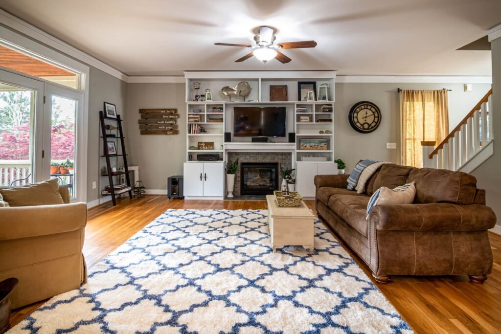 Warm and cozy living room featuring storage ottomans, nesting tables, a lift-top coffee table, and benches with hidden storage.