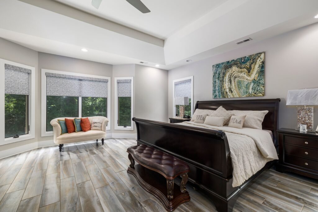 Modern master bedroom featuring soft lime wash walls, layered bedding, warm natural textures, and sophisticated decor, showcasing inspiring master bedroom design ideas.