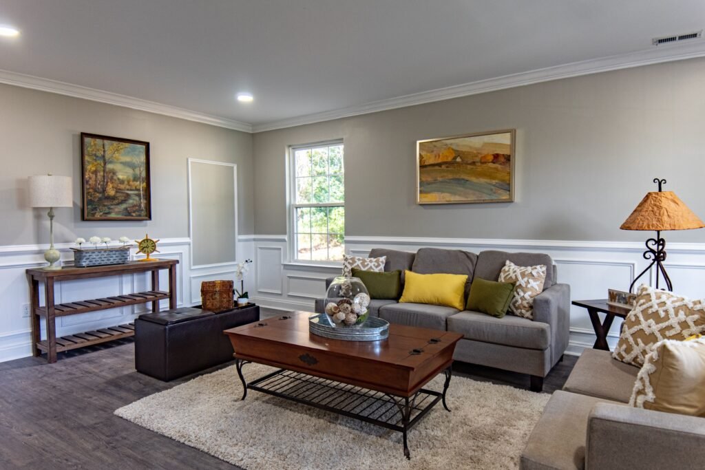 Warm and cozy living room featuring floor lamps, table lamps, wall sconces, and accent lighting that create a soft and inviting atmosphere.