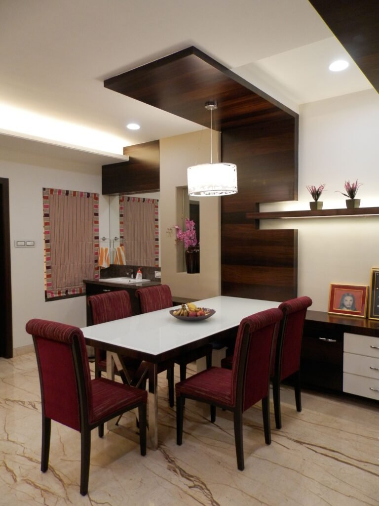 Modern dining room with wall decor, featuring framed artwork, stylish furniture, and elegant accents inspired by modern dining room ideas.