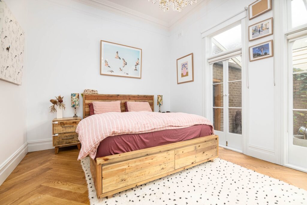 Affordable house in the USA featuring bedroom decorating ideas with a gallery wall of framed artwork, photos, and budget-friendly decorative accents.