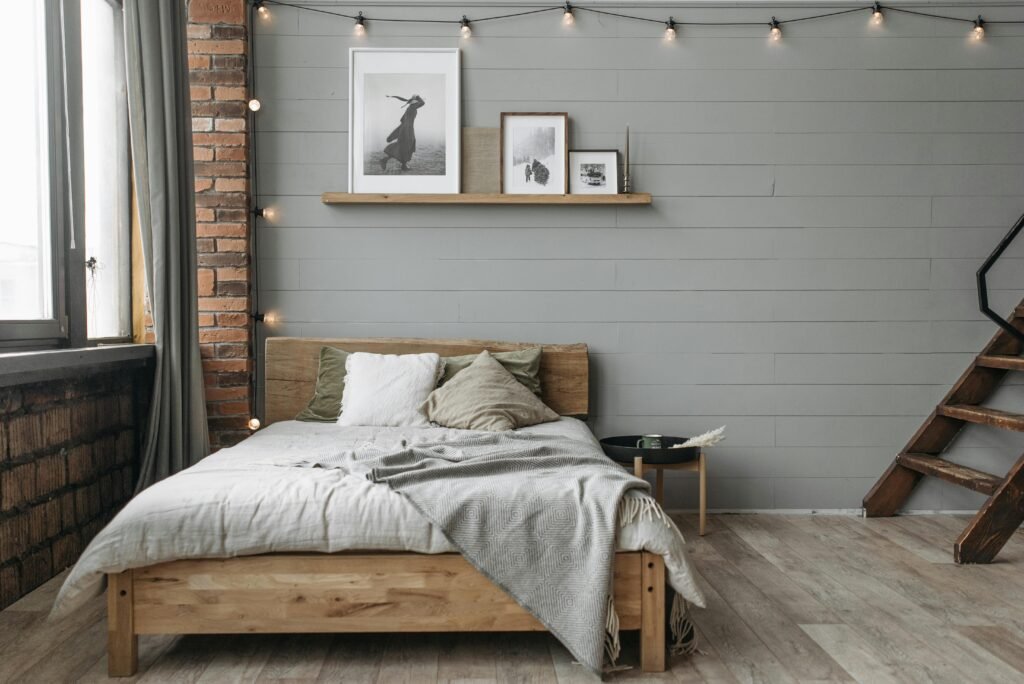 Affordable house in the USA featuring bedroom decorating ideas with designer-styled surfaces, curated decor, books, plants, and elegant accessories.