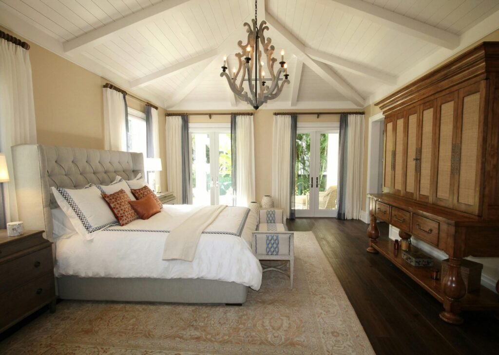 Master bedroom design ideas featuring an elegant chandelier, luxurious bedding, refined decor, and a spacious modern bedroom interior.