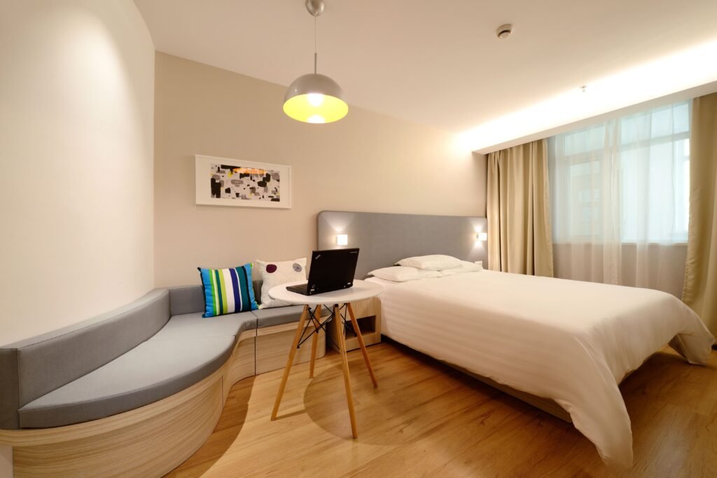 Modern master bedroom with curved interior element, featuring rounded wall details, soft edges, elegant furniture, and a contemporary luxury design.