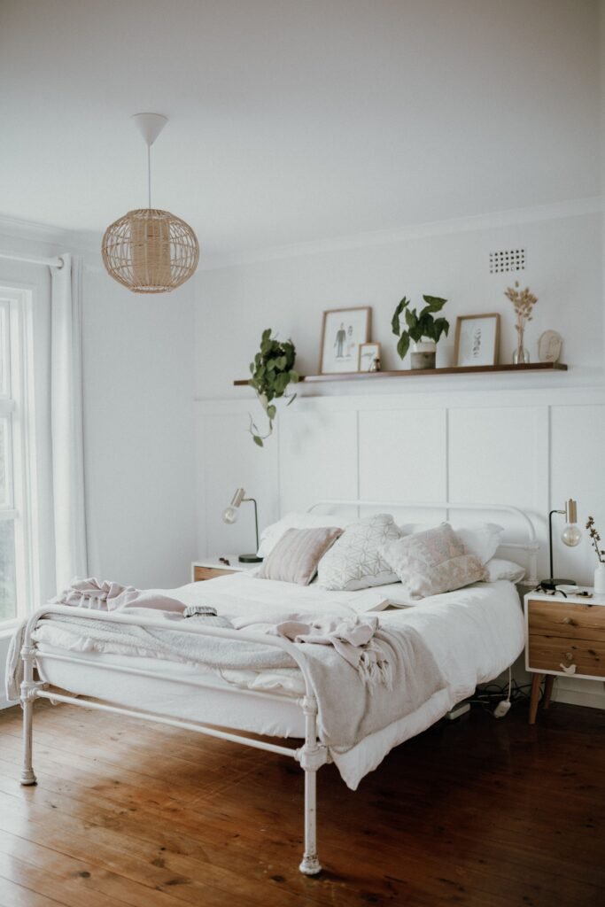 Affordable bedroom featuring natural indoor plants, warm wood furniture, and cozy decor from the most affordable bedroom furniture sets 2026.