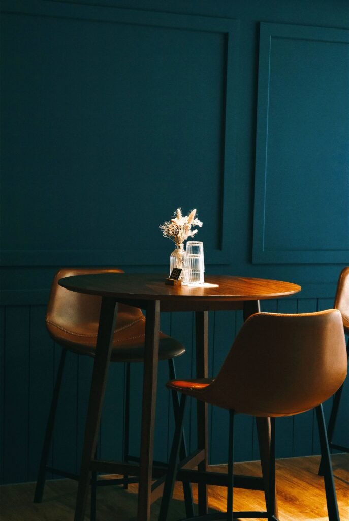 Modern dining room featuring a sleek dining table, elegant centerpiece arrangement, contemporary chairs, statement lighting, and sophisticated decor inspired by modern dining room ideas.