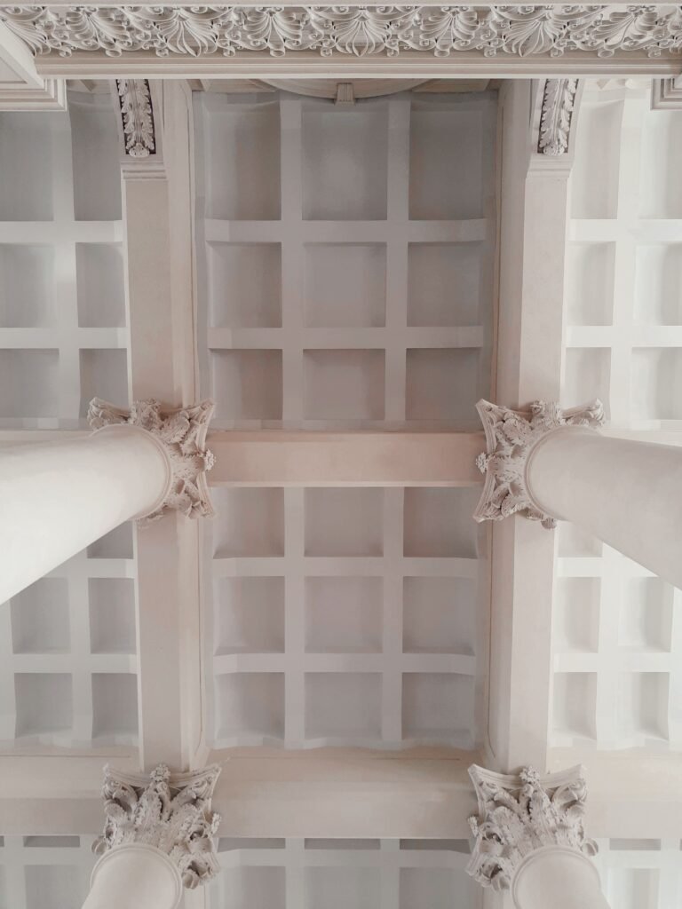 Classic white coffered ceiling with elegant square panels, decorative crown molding, and a timeless design for a bright and sophisticated interior.