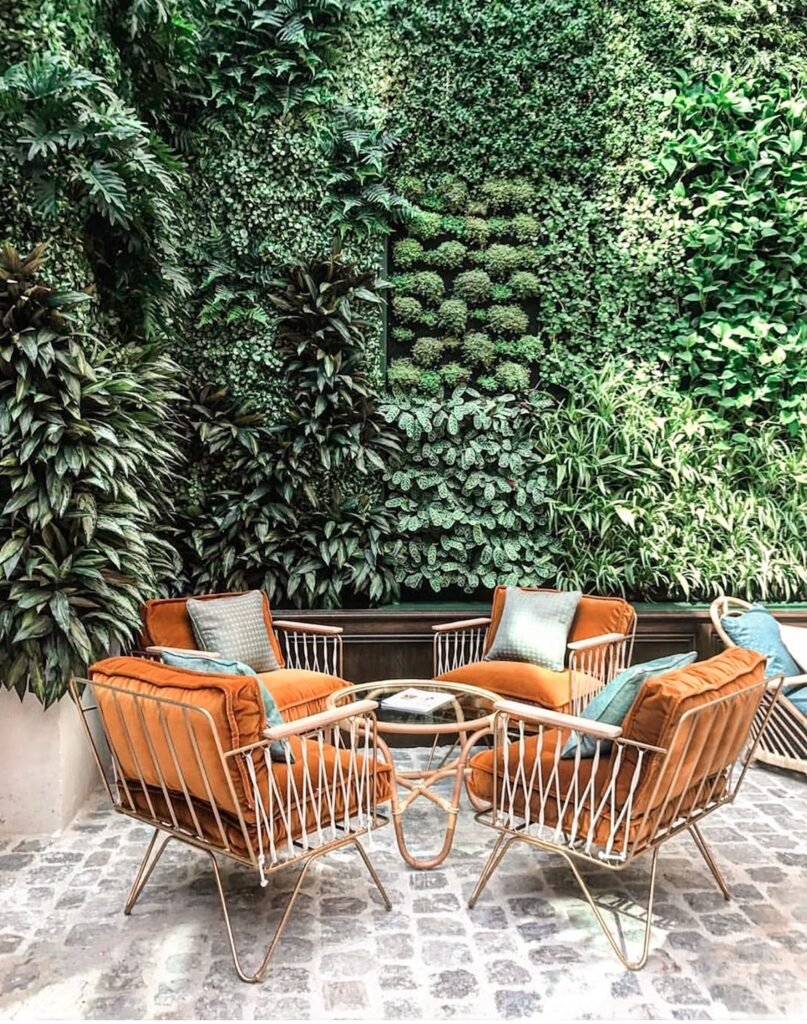 Modern xeriscaped backyard featuring drought-tolerant plants, decorative gravel, natural stone pathways, and a lush vertical garden wall for a stylish low-maintenance outdoor space.